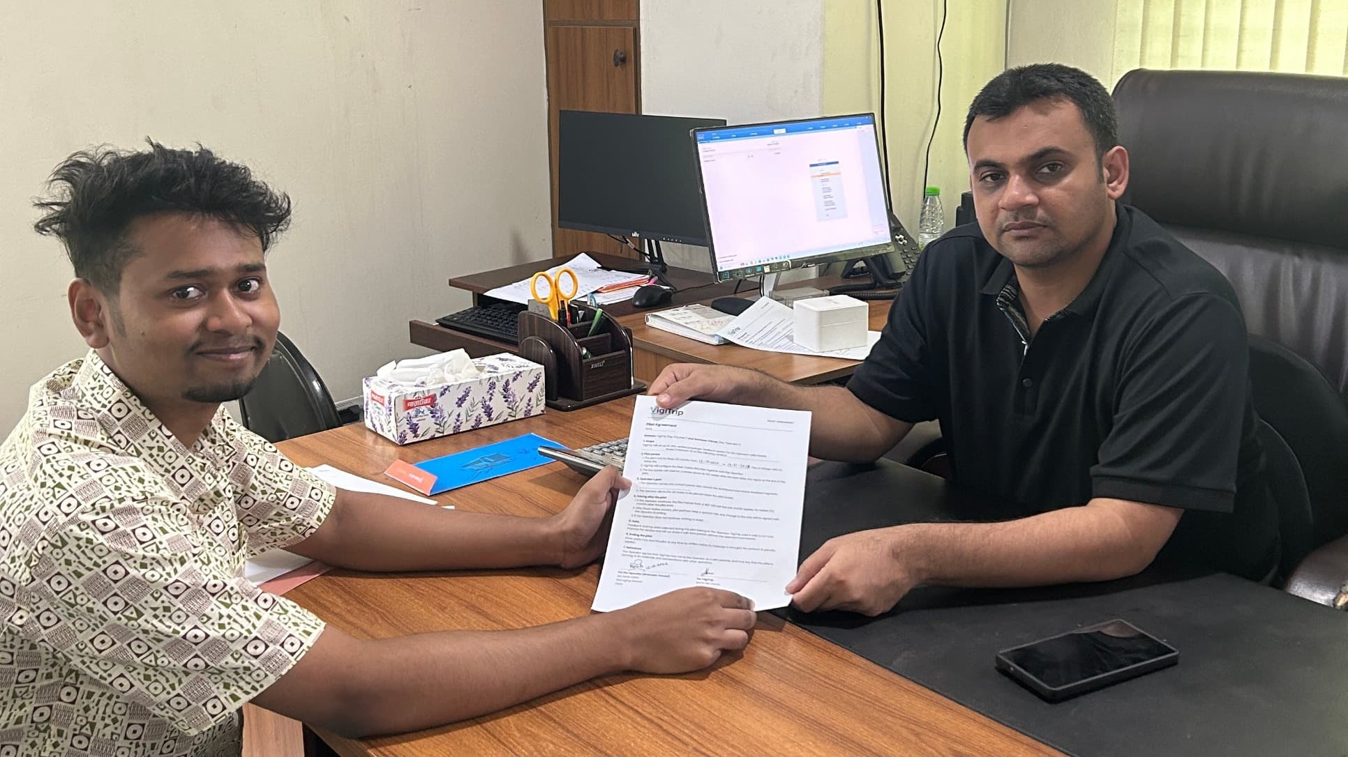 Mahin Bin Hasan, Founder of VigiTrip, and Md. Rakib Uddin, Managing Director of Grameen Travels, signing the pilot agreement on 12 October 2026.
